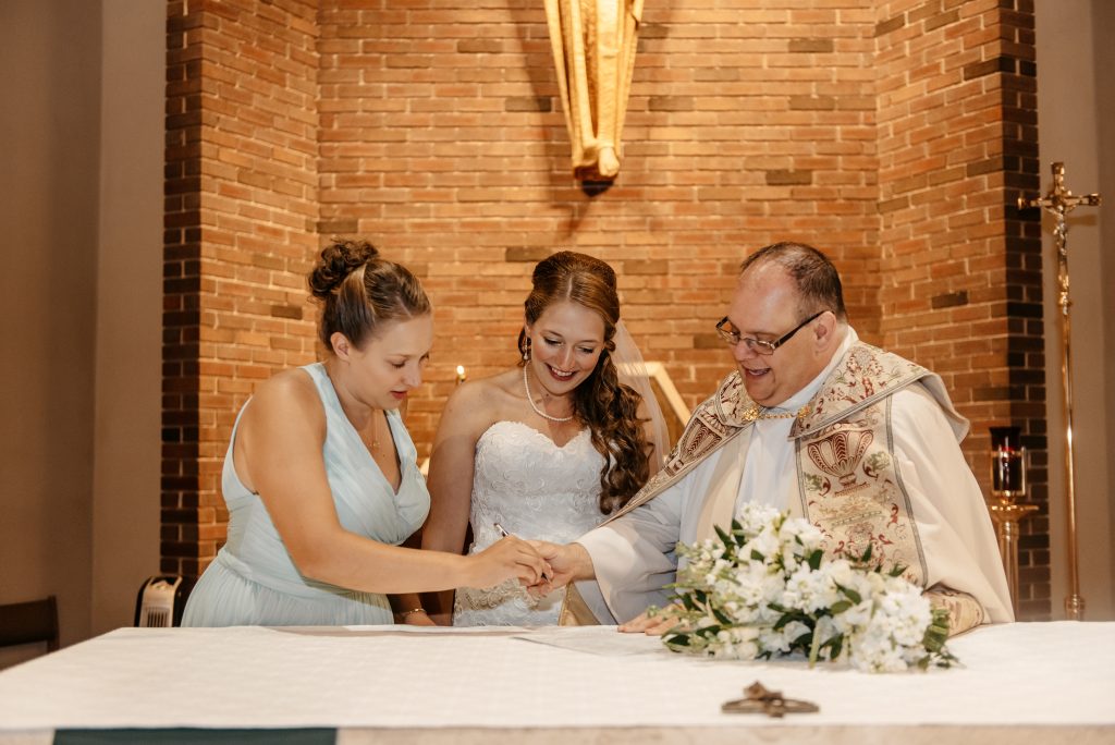 A priest explains how to get married in new york to a bride and her bridesmaid at their churhc wedding