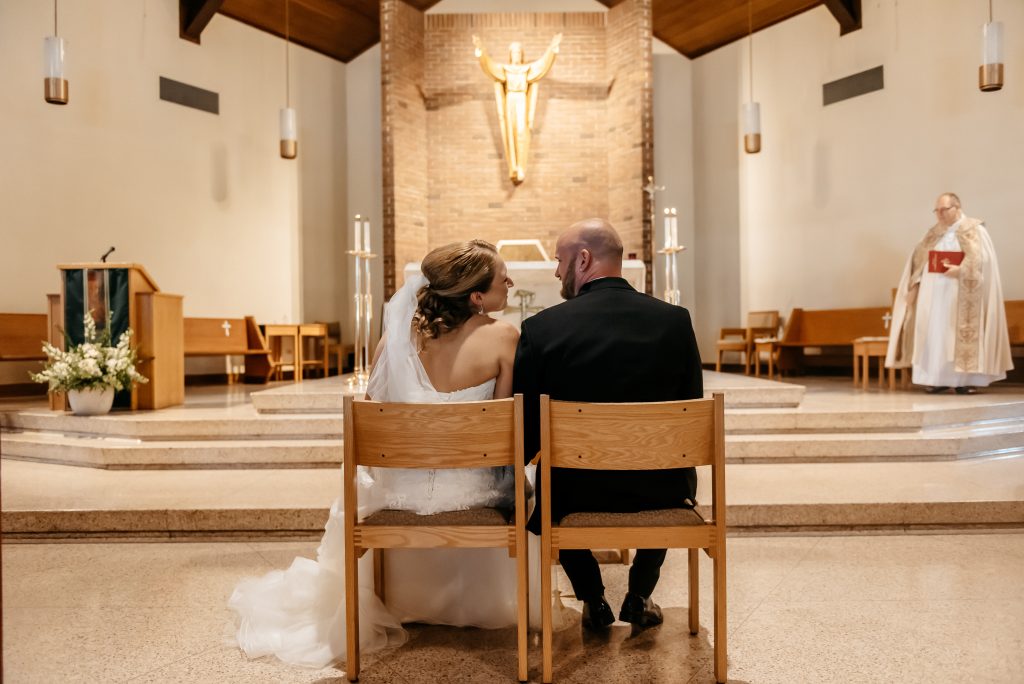 A bride and groom asked what are the requirements to get married in new york and now they are sitting at the alter on their wedding day preparing to say 'I do'
