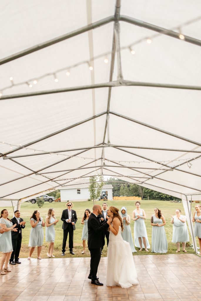 A bride and groom share their first dance after learning how many witnesses to get married in new york