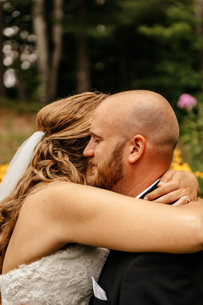 A bride embraces her groom after learning about the getting married in new york requirements