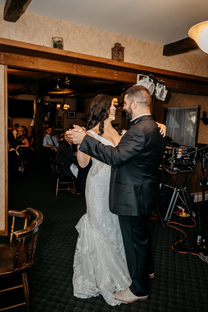 A bride and groom dance at their reception after paying the average cost of a wedding in upstate ny
