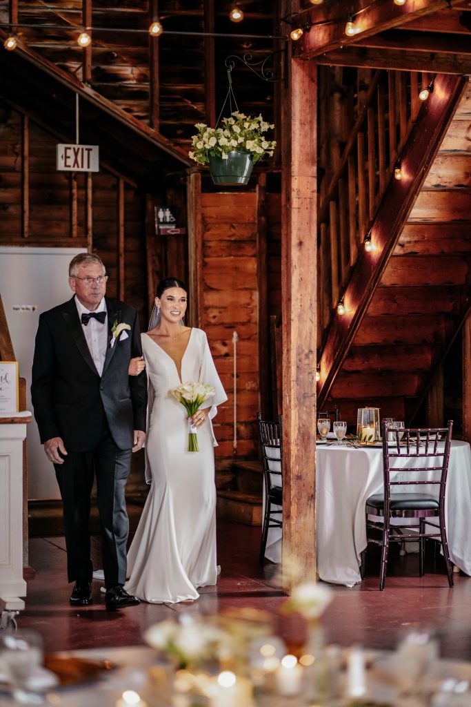 A bride and her father walk down the aisle at one of the best upstate new york wedding veneus
