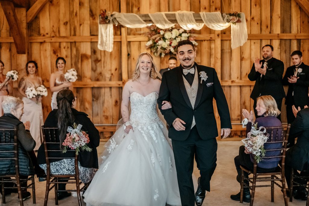 A bride and groom walk down the aisle after their nuptials at a
washington county wedding venue