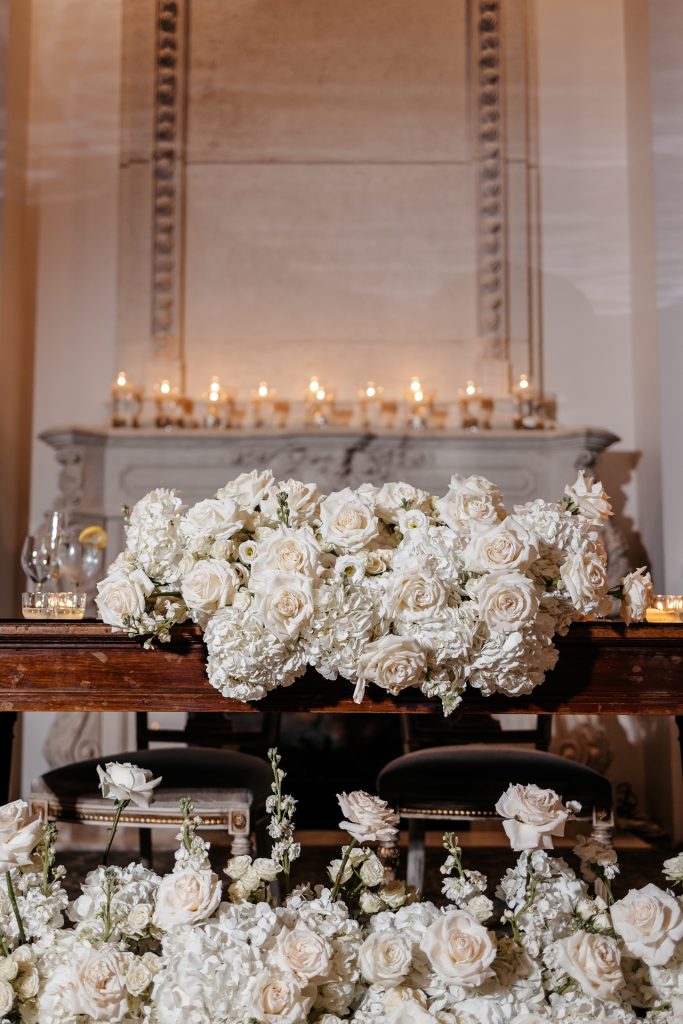 natural wedding photos are not complete without beatiful white rose flower arrangements and candles displayed for the ceremony
